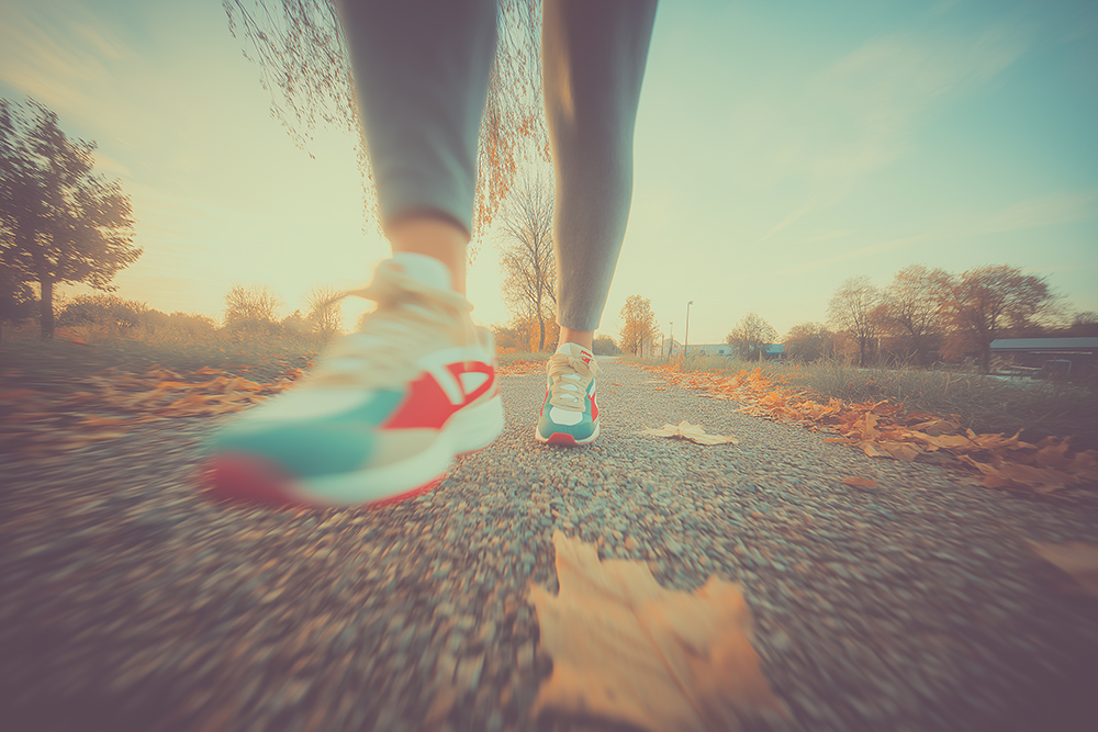 Woman running on gravel road